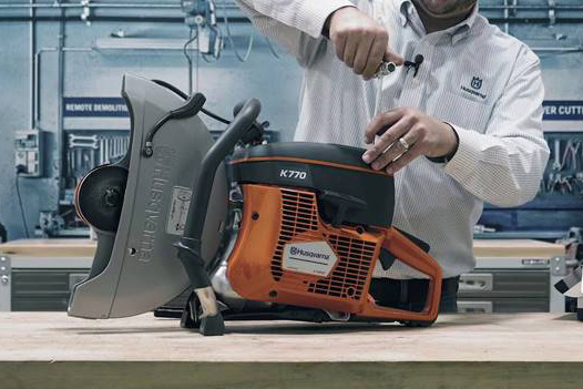 image of a man repairing a demo saw